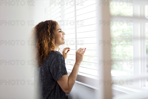 Woman looking through window