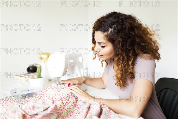 Woman using sewing machine