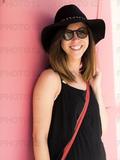 Woman under pink wall