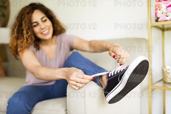 Woman putting on trainers