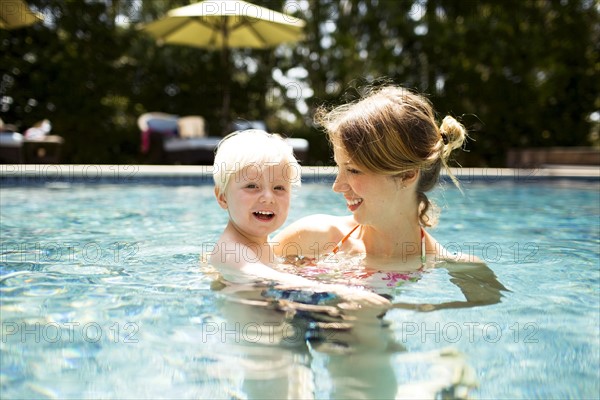 Mother with son (2-3) in swimming pool