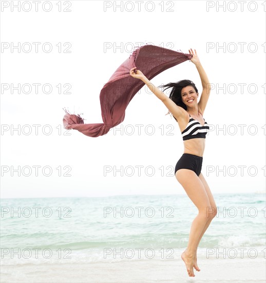 Woman jumping on beach