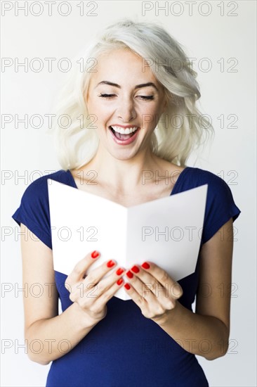 Studio shot of woman holding paper