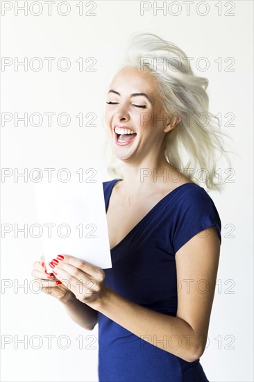 Studio shot of woman holding paper