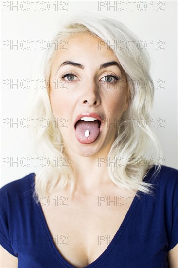 Studio shot of woman taking pill