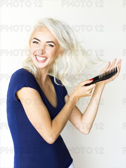 Studio shot of woman combing hair