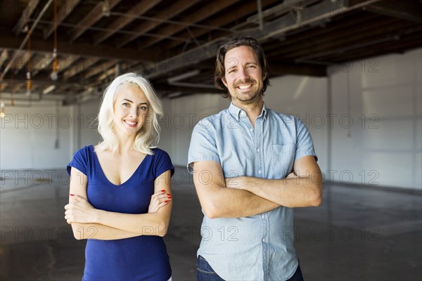 Woman and man standing in warehouse