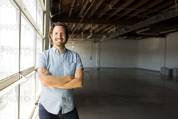 Man standing by window in warehouse