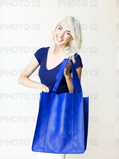 Studio shot of woman holding bag