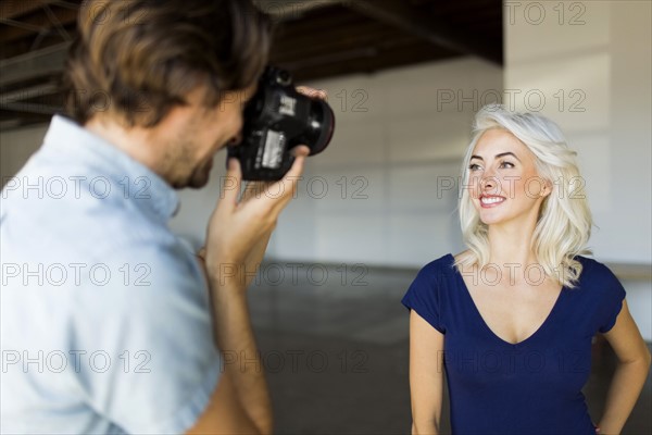 Man photographing woman