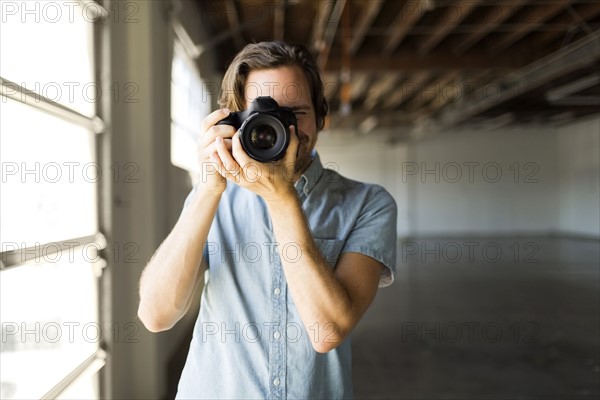 Portrait of man with digital camera