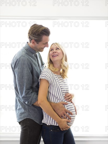 Husband embracing pregnant wife