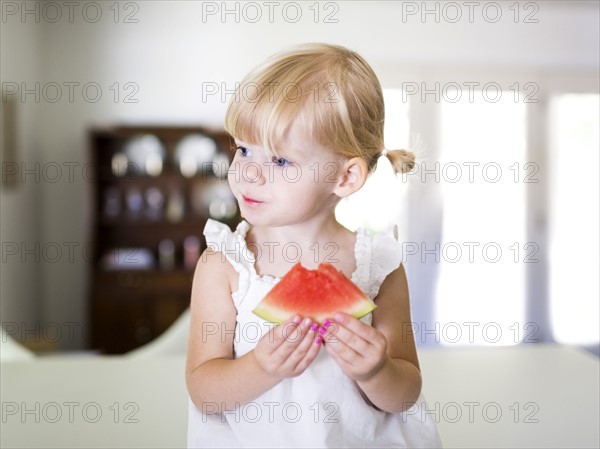 Portrait of girl (2-3) eating watermelon