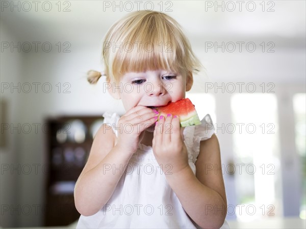 Portrait of girl (2-3) eating watermelon