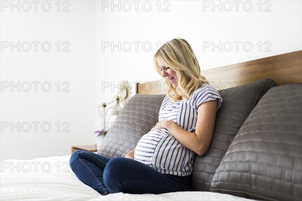 Portrait of pregnant woman touching belly