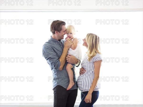 Family portrait of parents with daughter (2-3)