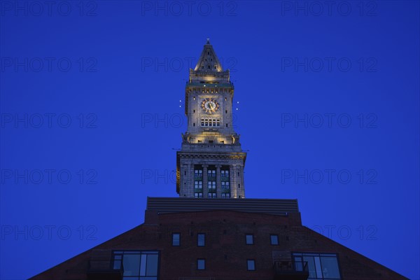 Illuminated clock tower at dawn