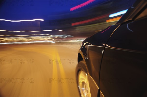 Car speeding at dusk
