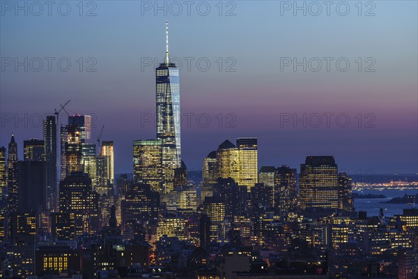 Illuminated skyline at sunrise. New York City, New York, USA.