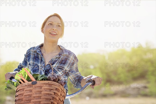 Portrait of young woman with bicycle.