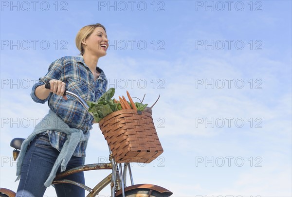 Portrait of young woman with bicycle.