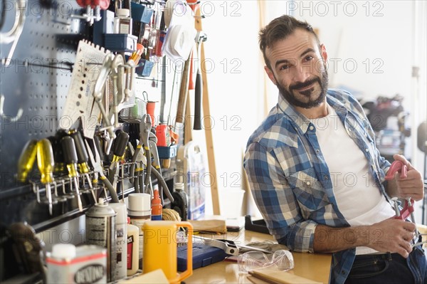 Portrait of man in workshop.