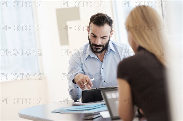 Man and woman working in office.