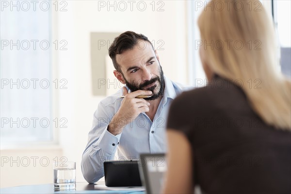 Man and woman sitting in office.