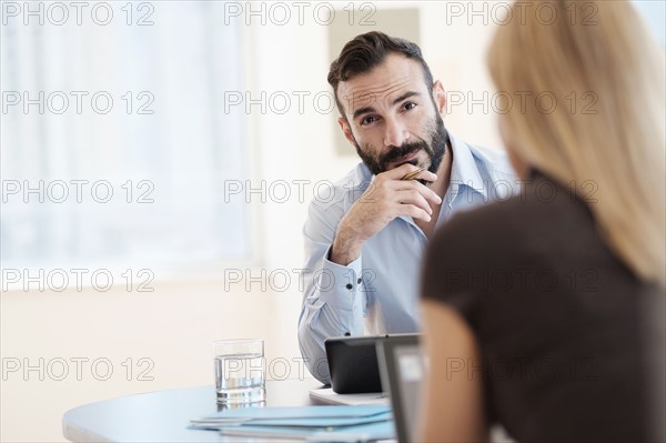 Man and woman sitting in office.