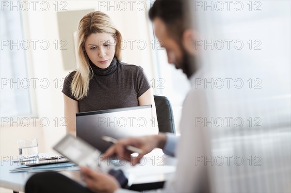 Man and woman working in office.