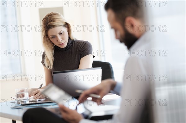 Man and woman working in office.