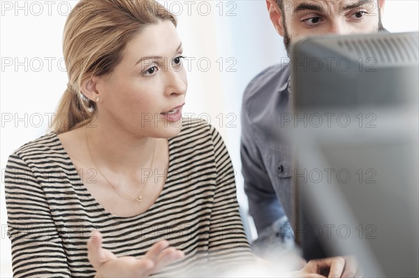 Man and woman looking at computer.