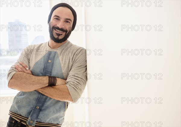 Portrait of man leaning on wall.