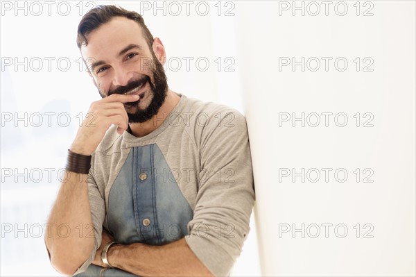Portrait of bearded man looking at camera.