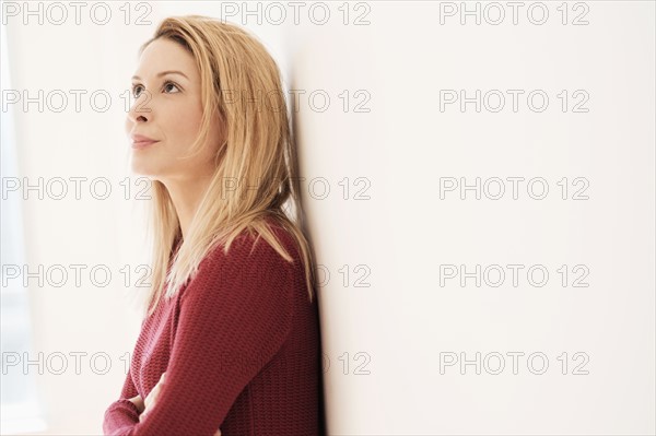 Portrait of young woman looking up.