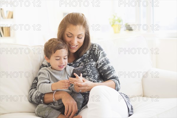 Mother and son (2-3) using mobile phone.