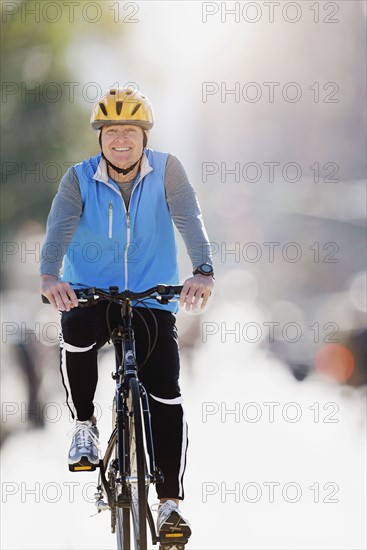 Mature man riding bicycle.