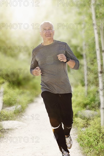 Man jogging on path in park.