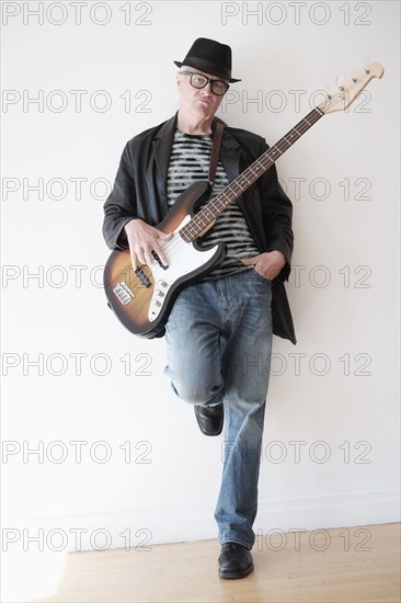 Portrait of cool man with bass guitar.