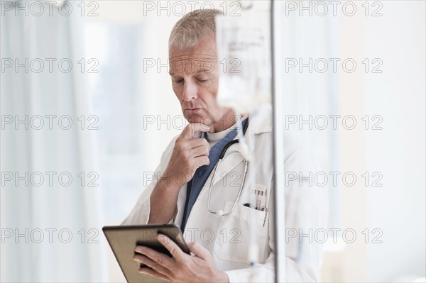 Doctor using tablet in hospital.