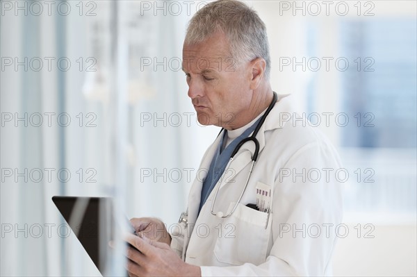 Doctor using tablet in hospital.