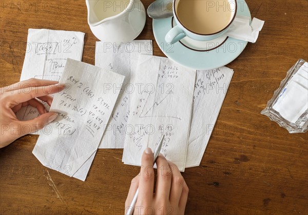 Woman writing on napkins.