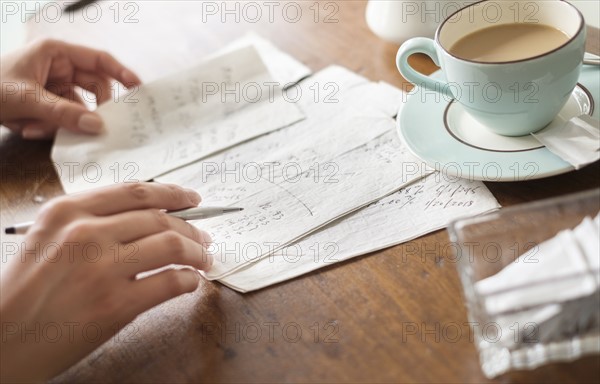 Woman writing on napkins.