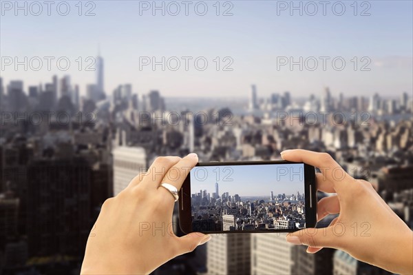 Hands photographing city. New York City, New York, USA.