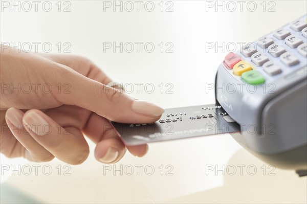 Young woman paying with credit card.