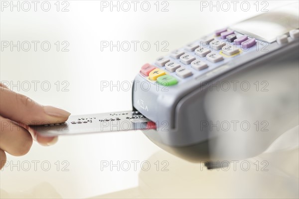 Young woman paying with credit card.