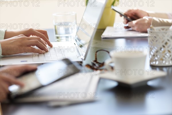 Hands using tablet pc, laptop and smart phone.