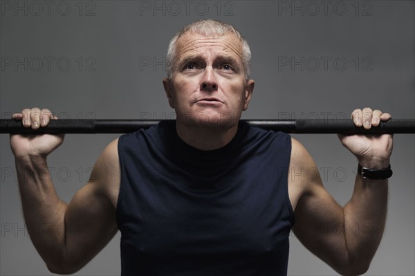 Man in health club weight lifting.