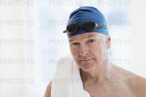 Portrait of man in swimming cap and swimming goggles.