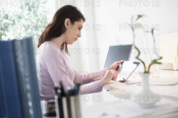 Young woman using digital tablet.